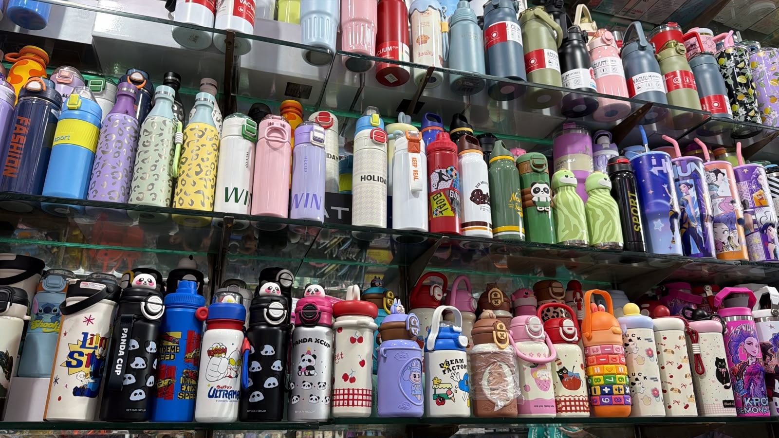 Shelves of colourful kids' water bottles in assorted designs